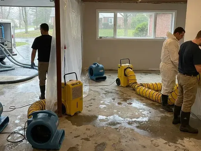 Workers and drying equipment across an affected ground floor